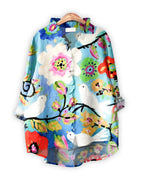 Colorful floral and bird patterned dress on a  Blue background