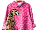 Pink checkered shirt with a leopard design on a hanger